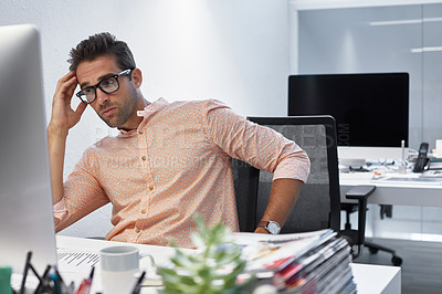Buy stock photo Cropped shot of a businessman looking stressed while sitting at his desk