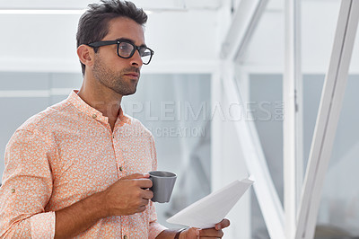 Buy stock photo Cropped shot of a businessman going over some paperwork
