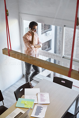 Buy stock photo Shot of a businessman using his cellphone in his office