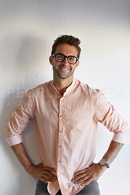 Buy stock photo Cropped shot of a handsome young businessman posing against a white wall