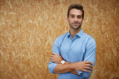 Buy stock photo Cropped shot of a handsome young man posing against a wooden background