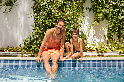 Buy stock photo Portrait of a father and his son enjoying a day by the swimming pool