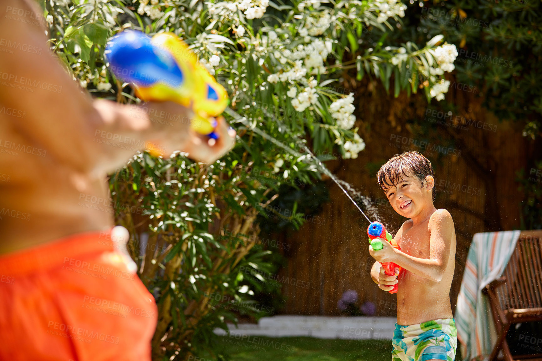 Buy stock photo Water gun, smile and father with son at swimming pool for bonding, connection and summer vacation. Toy, games and holiday with man and child in backyard of family home for happy, relax and playful