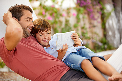 Buy stock photo Shot of a young boy and his father bonding outdoors