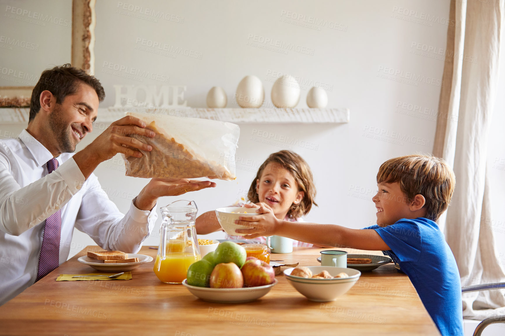 Buy stock photo Cropped shot of a young family having breakfast together at home