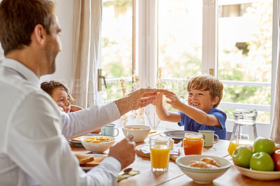 Buy stock photo Cropped shot of a young family having breakfast together at home