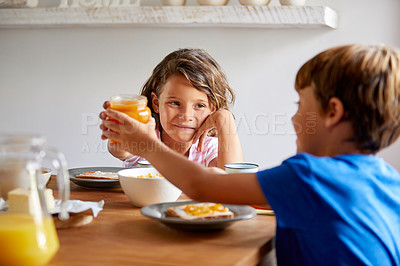 Buy stock photo Cropped shot of siblings having breakfast together at home