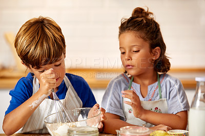 Buy stock photo Cropped shot of an adorable brother and sister baking in the kitchen