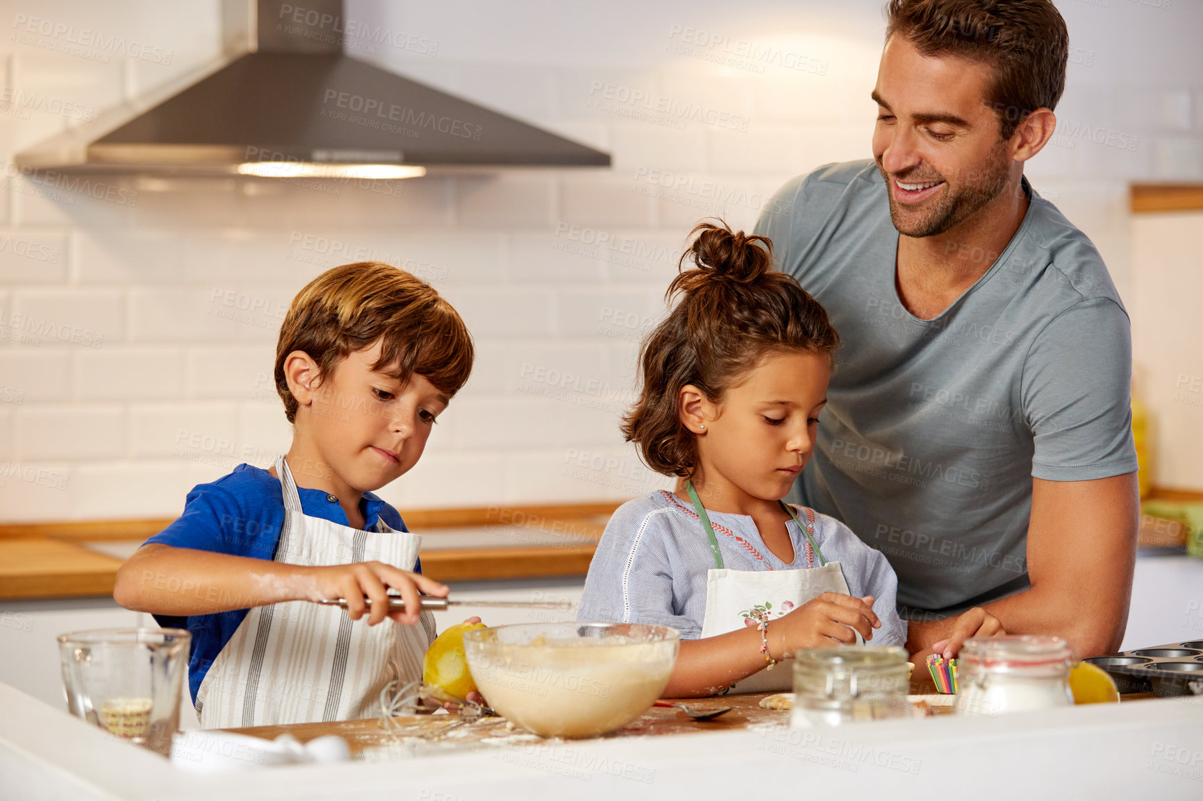 Buy stock photo Cropped shot of a father helping his son and daughter bake in the kitchen at home