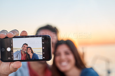 Buy stock photo Shot of a young couple taking a selfie together on an ocean cruise