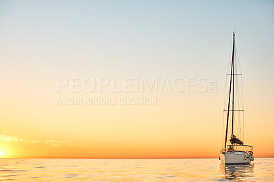 Buy stock photo Shot of a young couple going for an ocean cruise at sunset