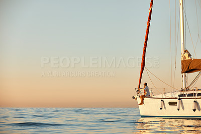 Buy stock photo Shot of a young man going for an ocean cruise on a boat