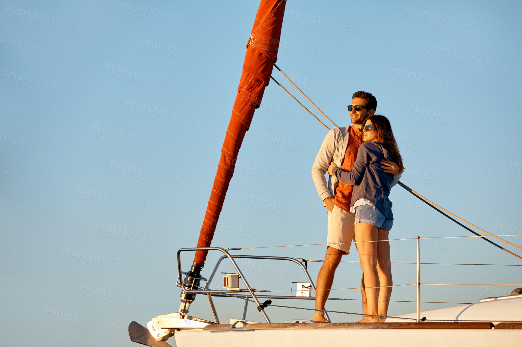 Buy stock photo Shot of a young couple enjoying a cruise out on the ocean