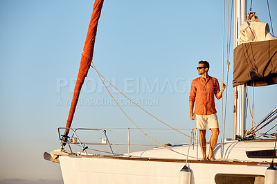 Buy stock photo Shot of a young man going for an ocean cruise on a boat