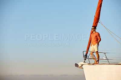 Buy stock photo Shot of a young man going for an ocean cruise on a boat