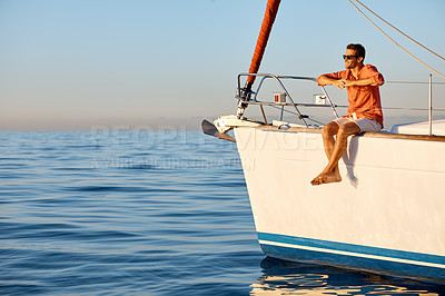 Buy stock photo Shot of a young man going for an ocean cruise on a boat