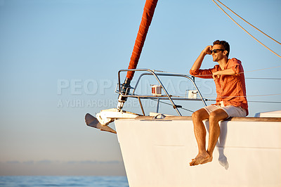 Buy stock photo Shot of a young man going for an ocean cruise on a boat