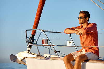 Buy stock photo Shot of a young man going for an ocean cruise on a boat