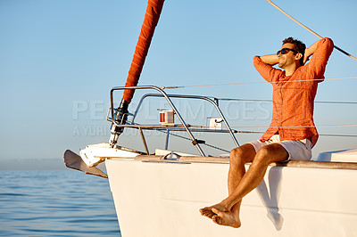 Buy stock photo Shot of a young man going for an ocean cruise on a boat