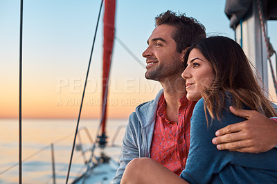 Buy stock photo Shot of a young couple enjoying a cruise out on the ocean