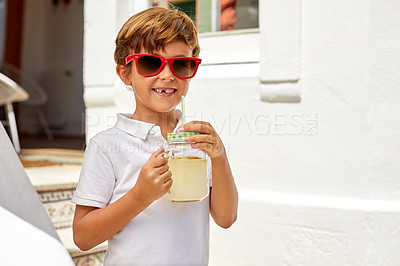 Buy stock photo Portrait of an adorable little boy drinking lemonade on a summer's day outdoors