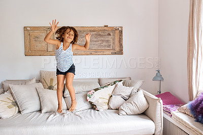 Buy stock photo Shot of a child having fun while jumping on a sofa