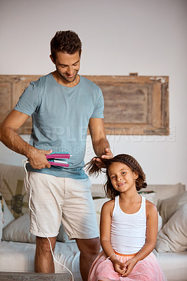 Buy stock photo Cropped shot of a father straightening his daughter's hair