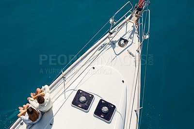 Buy stock photo High angle shot of an affectionate young couple enjoying a yacht cruise