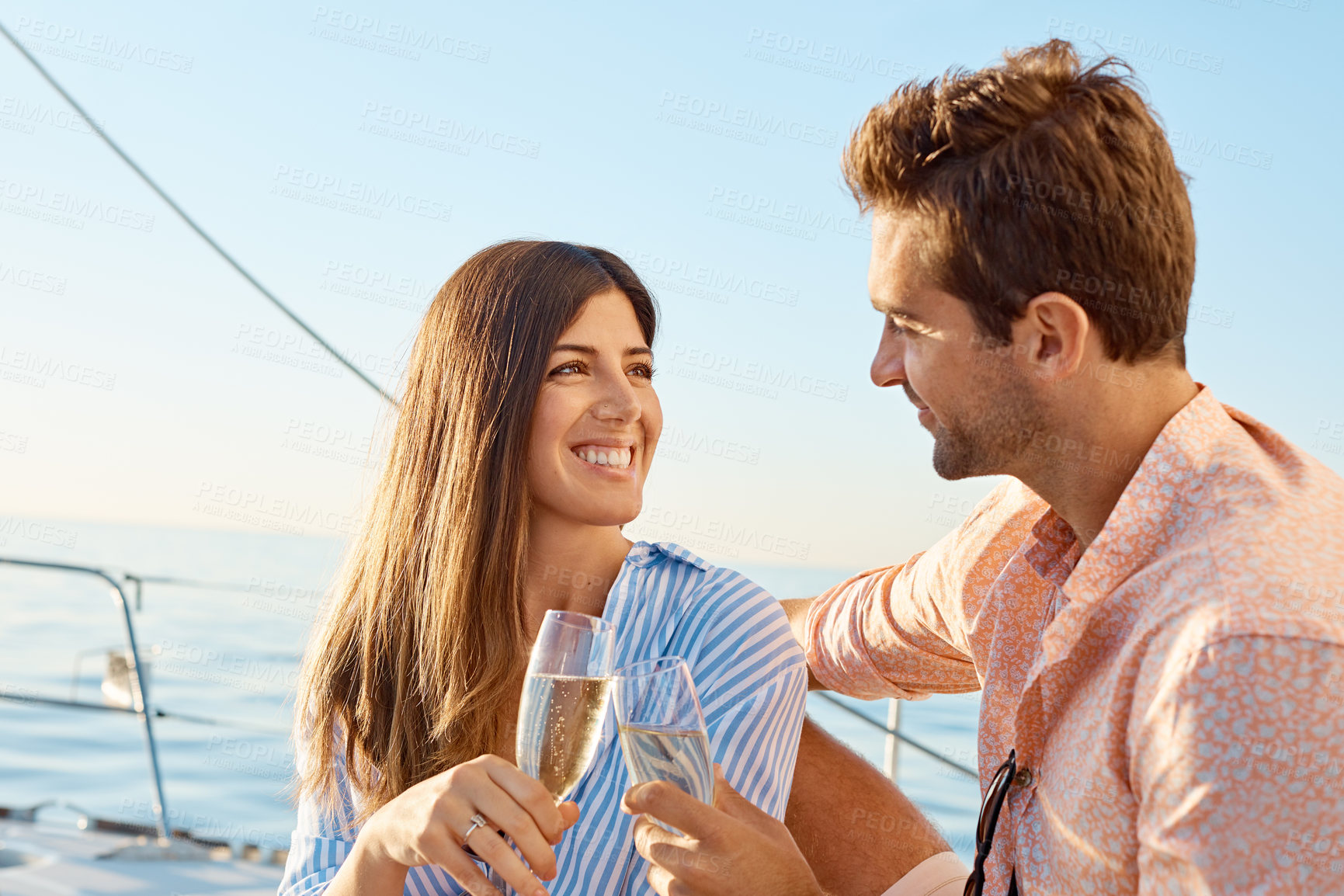 Buy stock photo Couple, cheers and yacht on ocean with champagne, love or summer holiday for anniversary celebration. Happy, married people and toast on boat with drink, relationship goals or travel vacation at sea.