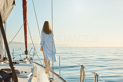 Buy stock photo Rearview shot of a beautiful young woman going for an ocean cruise on a boat
