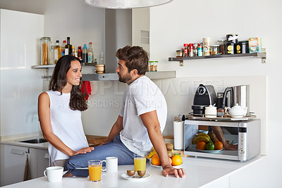 Buy stock photo Shot of a young couple having a relaxing breakfast together at home