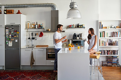 Buy stock photo Shot of a young couple having a relaxing breakfast together at home