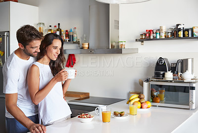 Buy stock photo Shot of a young couple having a relaxing breakfast together at home
