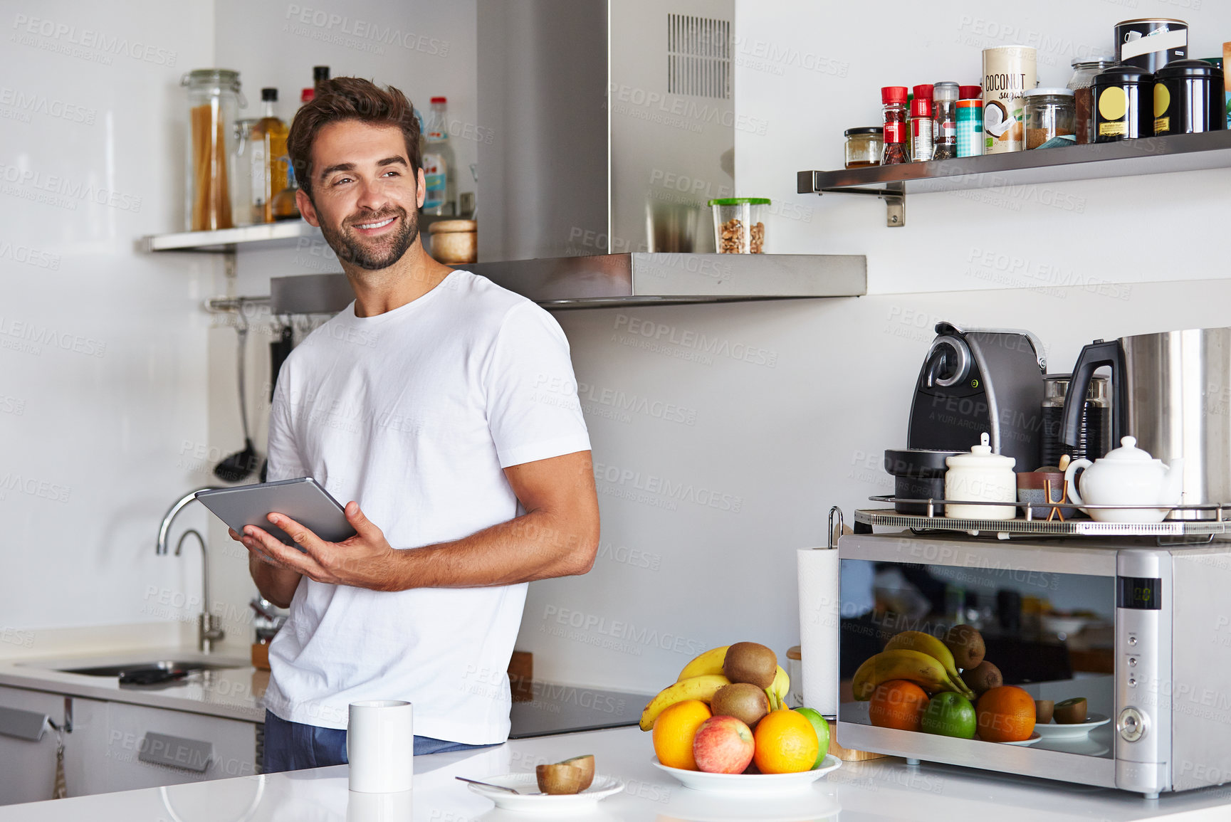 Buy stock photo Tablet, morning and man in kitchen of home with networking, communication or social media. Smile, digital tech and person with reading for ebook, texting or chatting in apartment on mobile app