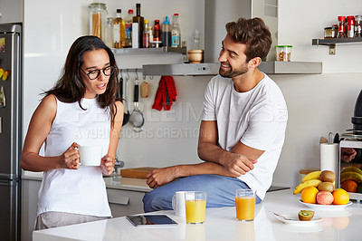 Buy stock photo Shot of a young couple using a digital tablet together during their morning routine at home