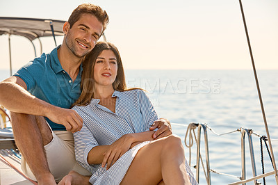 Buy stock photo Shot of a young couple enjoying a cruise out on the ocean