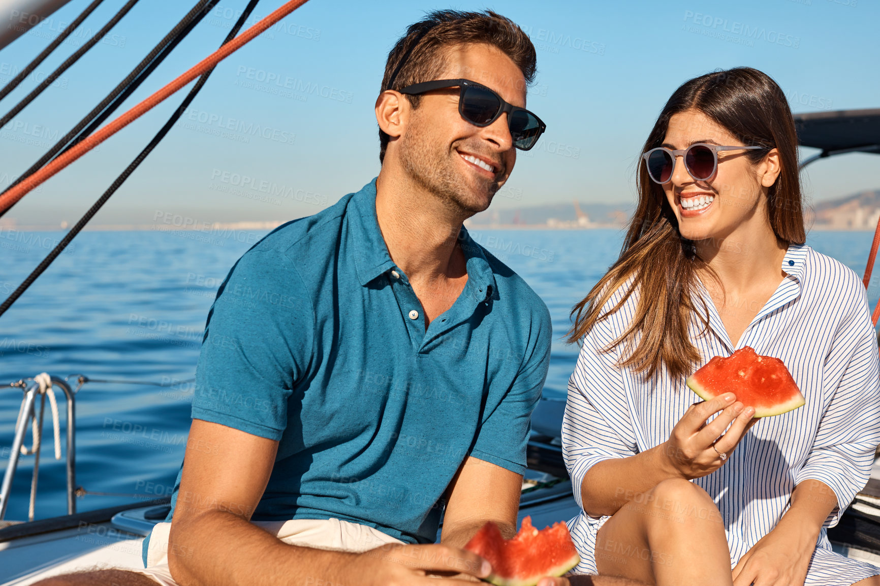Buy stock photo Watermelon, relax and travel with couple on yacht for summer cruise, honeymoon and sunglasses. Happy, romantic getaway and sailing with man and woman with fruit for food, holiday trip and boat