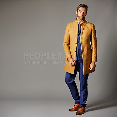 Buy stock photo Studio portrait of a handsome young businessman posing against a dark background