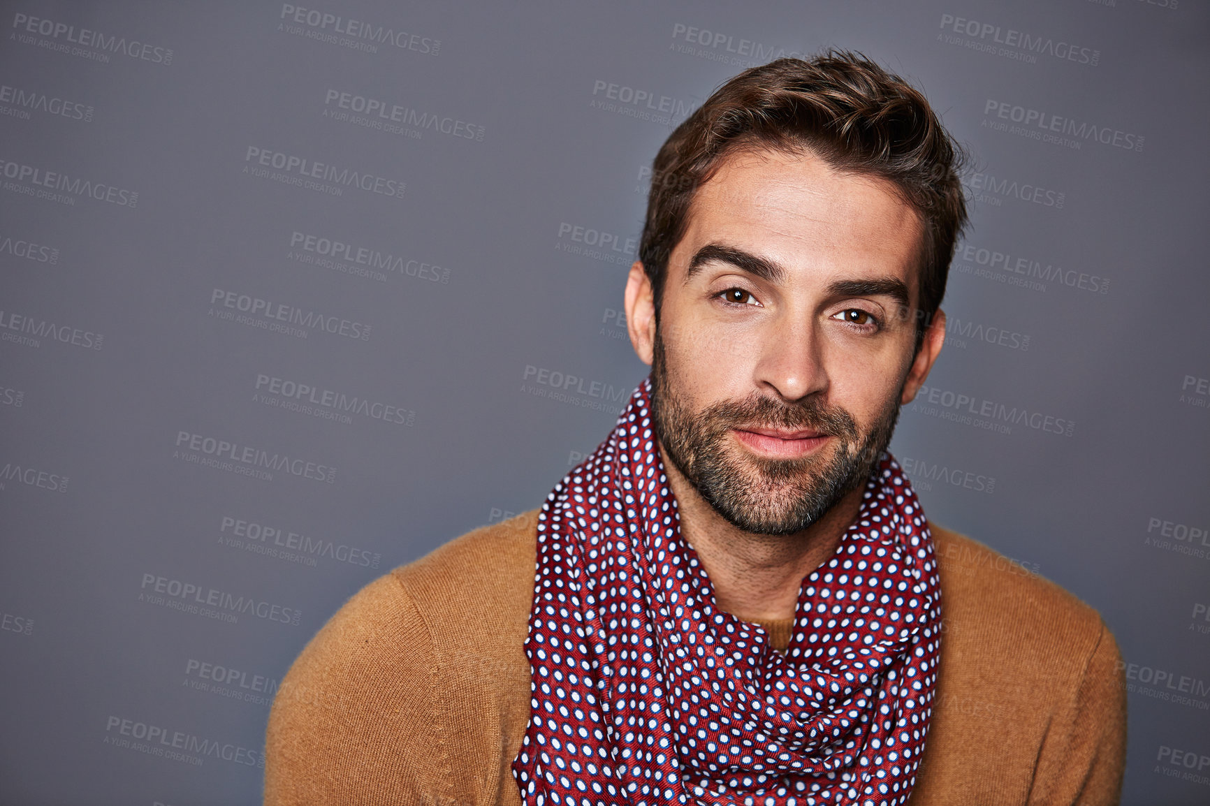Buy stock photo Studio portrait of a handsome young man posing against a grey background