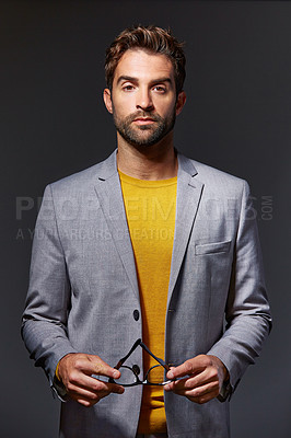 Buy stock photo Studio portrait of a handsome young businessman standing against a grey background