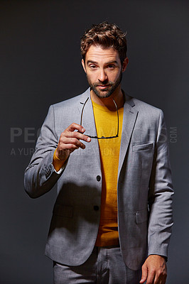 Buy stock photo Studio portrait of a handsome young businessman standing against a grey background