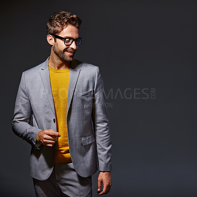 Buy stock photo Studio shot of a handsome young businessman standing against a grey background
