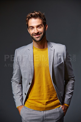 Buy stock photo Studio portrait of a handsome young businessman standing against a grey background