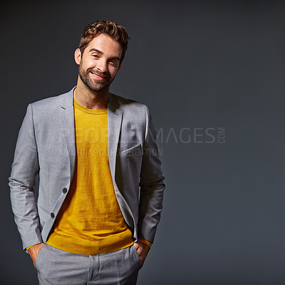 Buy stock photo Studio portrait of a handsome young businessman standing against a grey background