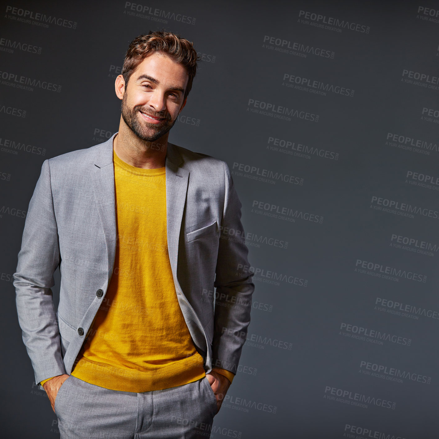 Buy stock photo Studio portrait of a handsome young businessman standing against a grey background