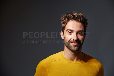 Buy stock photo Studio portrait of a handsome man posing against a grey background