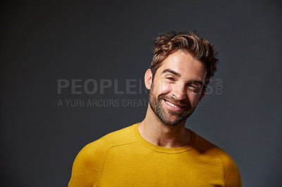 Buy stock photo Studio portrait of a handsome man posing against a grey background
