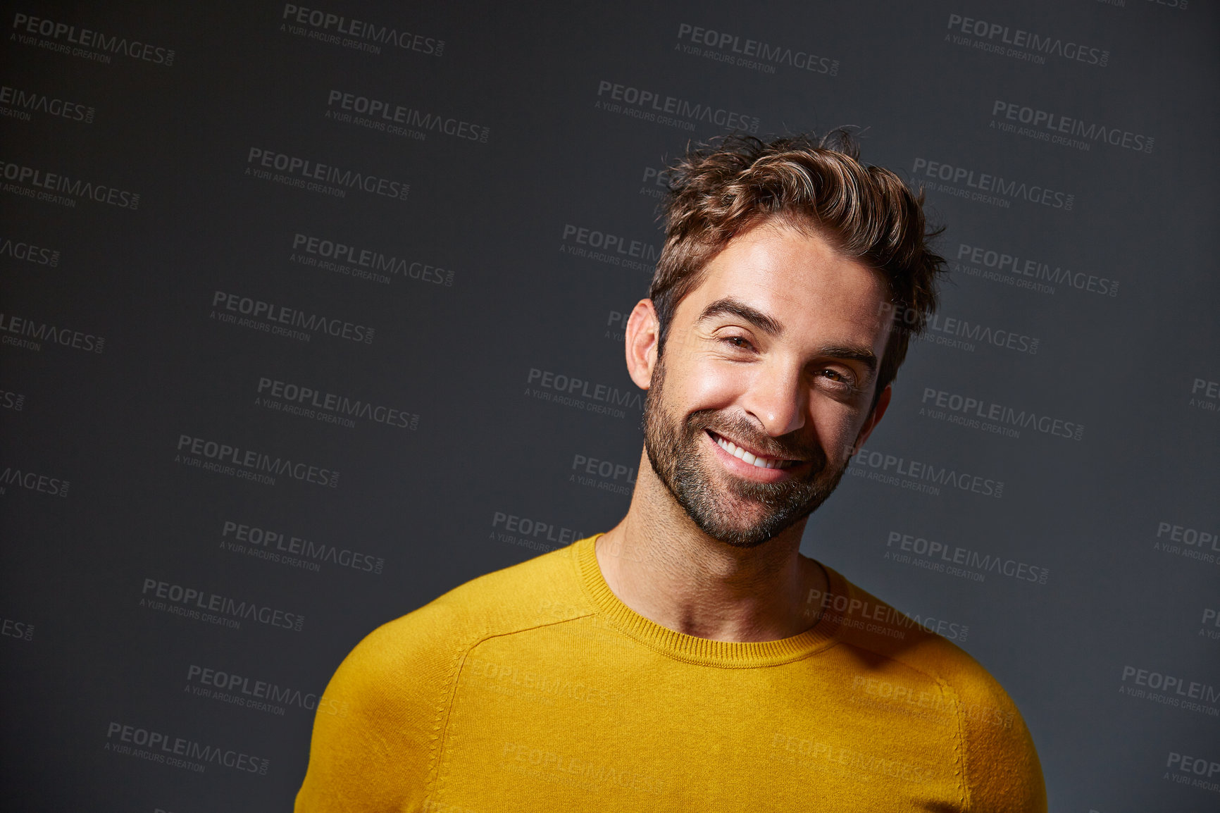 Buy stock photo Studio portrait of a handsome man posing against a grey background
