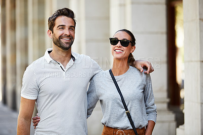 Buy stock photo Shot of an affectionate young couple exploring a foreign city