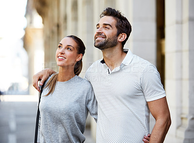Buy stock photo Shot of an affectionate young couple exploring a foreign city